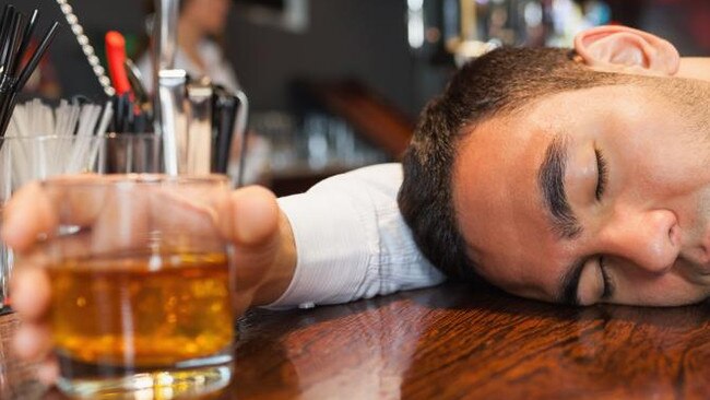 Drunk and unconscious businessman lying on a counter