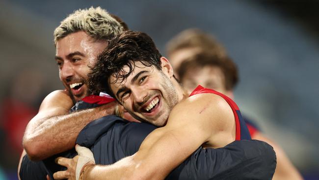 Christian Petracca and Christian Salem hug Goodwin after the amazing Round 23 victory.