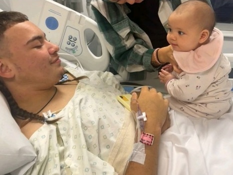 Isaeah receiving a visit from his baby sister Sunni while admitted at the Mater Hospital. Photo: Supplied