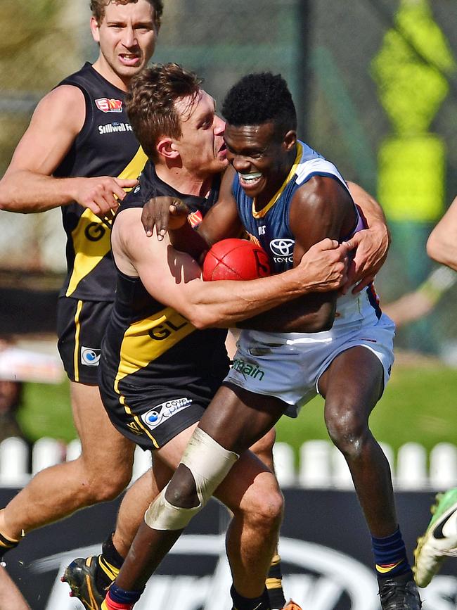 Glenelg’s Ben Sawford tackles Adelaide's Aron Asfaha during their clash at Glenelg Oval on Saturday. Picture: Tom Huntley