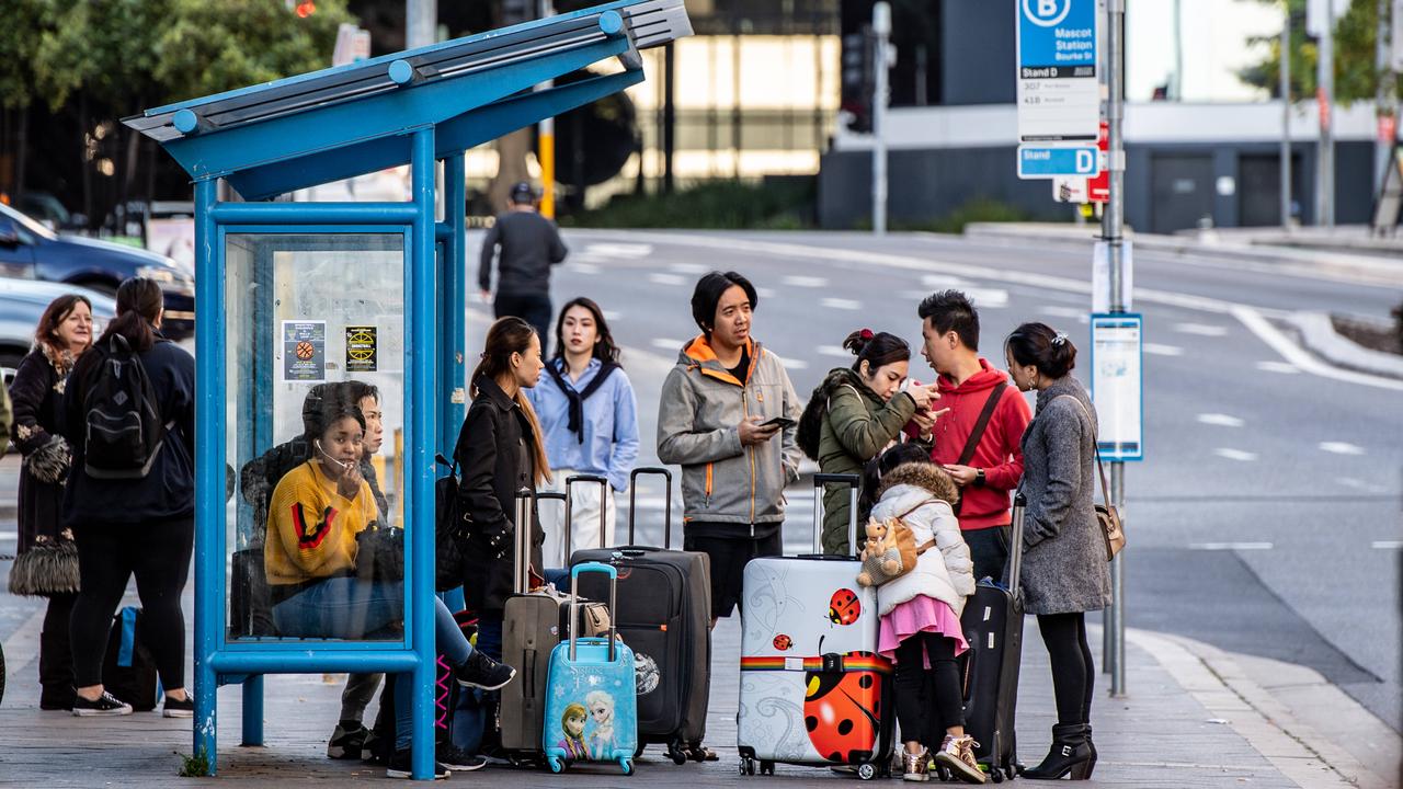 People with luggage waiting outside Mascot Towers this morning. Picture: Monique Harmer