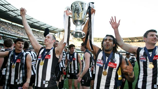 Collingwood players celebrate victory in the Grand Final replay in 2010.