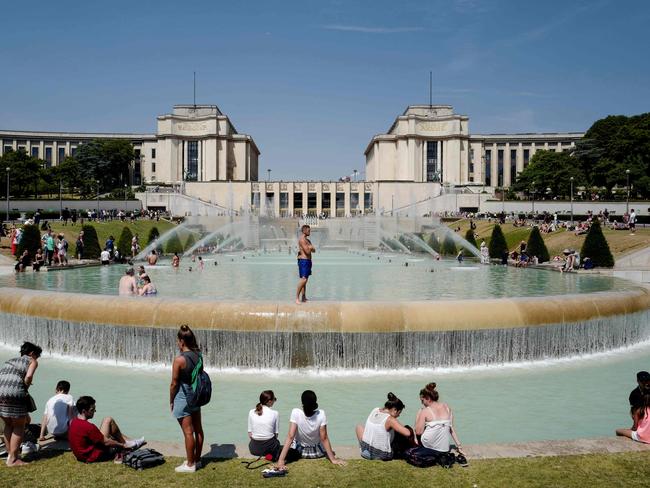 People cool themselves at the Trocadero Fountain in Paris. Picture: Ludovic Marin