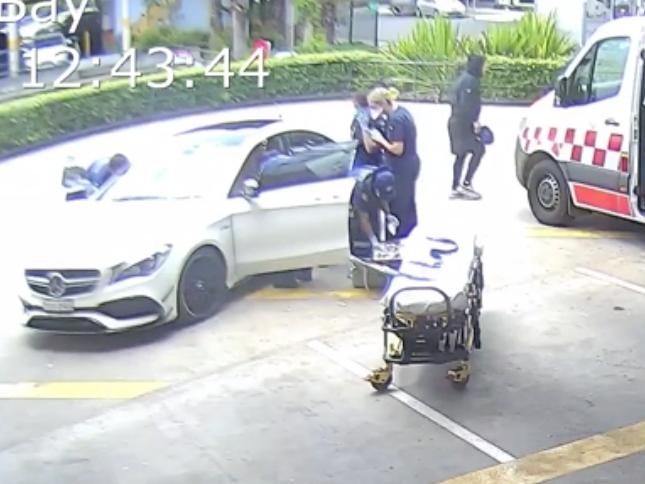 Ambulance personnel tend to the woman as she’s dropped off. Picture: NSW Police