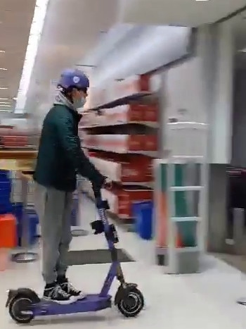 A young man rides an e-scooter through the New Town Plaza Kmart. Picture: Supplied