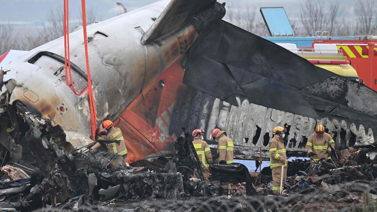 Firefighters and recovery teams work at the scene. Picture: UNG YEON-JE / AFP