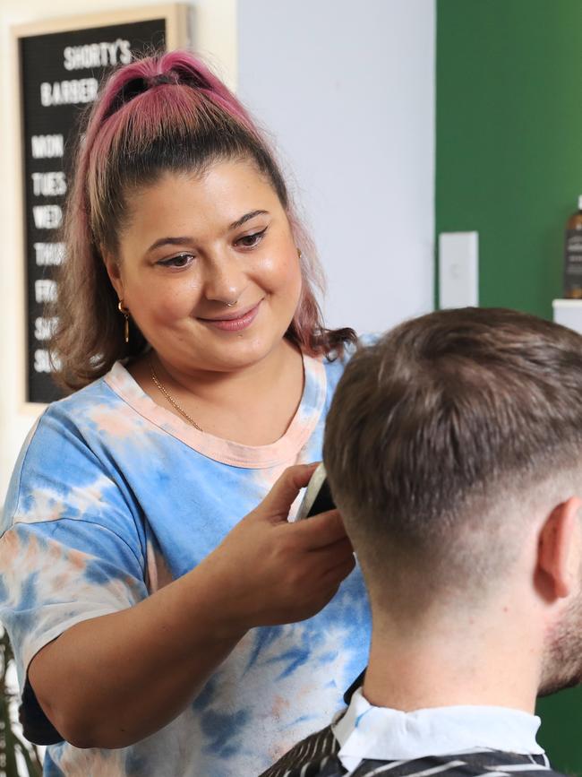 Shorty's Barber shop owner Lianne Wright, pictured with customer Ben Morris, said her only responses to employment adds are coming from backpackers. Picture: Brendan Radke