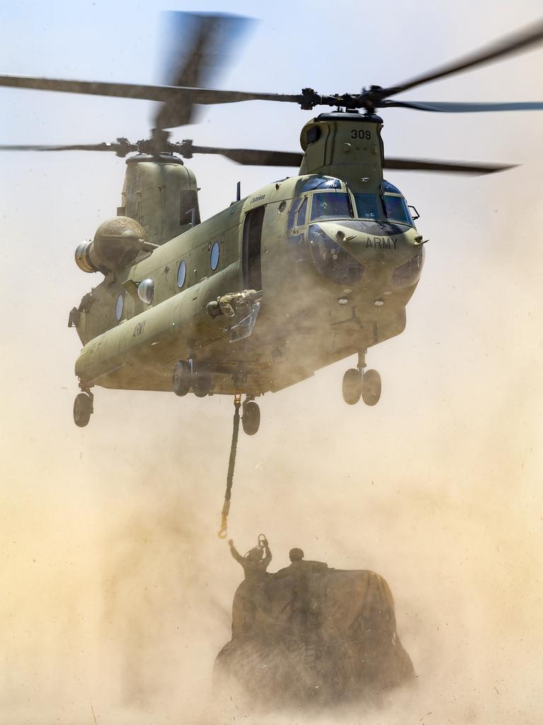 Australian Army CH-47 Chinooks from the 5th Aviation Regiment, load hay bales to deliverto remote bushfire effected farms on Kangaroo Island during OP Bushfire Assist. *** Local Caption *** CH-47 Chinook helicopters from the Australian Army's 5th Aviation Regiment have been helping to quickly pick up and drop off hay to feed livestock at hard to reach properties on Kangaroo Island as part of Operation Bushfire Assist 2019-2020.