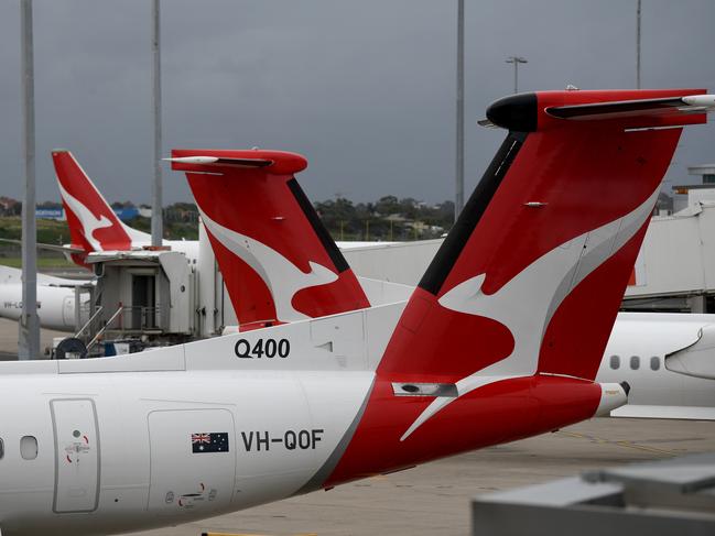 SYDNEY, AUSTRALIA - NCA NewsWire Photos DECEMBER, 31, 2020: The tails of grounded Qantas planes are seen on the tarmac at Sydney Domestic Airport. Victoria has announced a hard border closure with NSW from 11:59pm on January 1, whilst SA will reimpose its hard border closure with NSW from midnight January 1, following 10 new COVID-19 cases in NSW today. Picture: NCA NewsWire/Bianca De Marchi