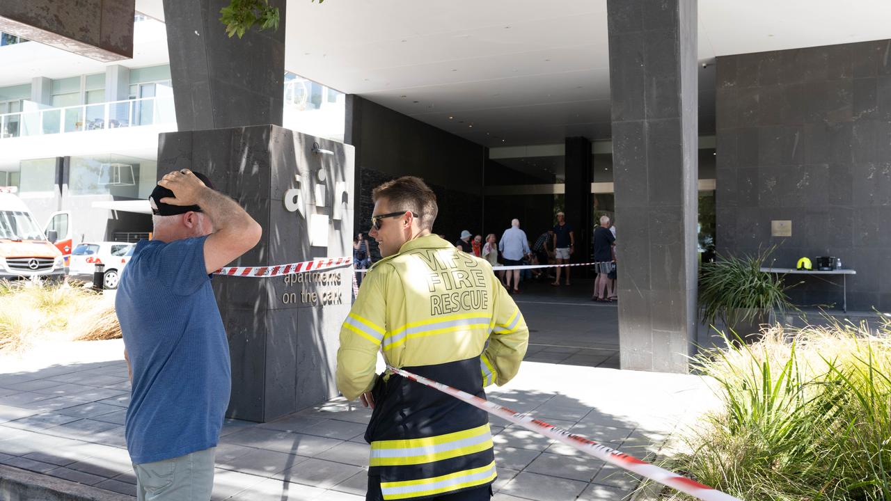 A firey speaks to a resident at the apartment block. Picture: The Advertiser/ Morgan Sette