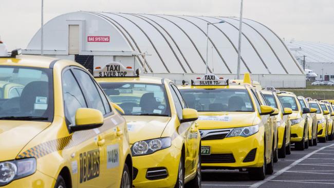 Touting drivers try to take business from taxis queued up at the airport. Picture: Jason Edwards