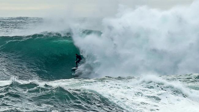 Surfers take advantage of the big waves at Bicheno during a swell in early 2021. Picture: Zak Simmonds