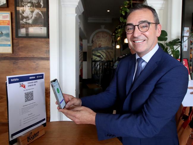 ADELAIDE, AUSTRALIA - DECEMBER 01: South Australian Premier Steven Marshall demonstrates checking in via QR code to help with contact tracing at the Stag Hotel on December 01, 2020 in Adelaide, Australia. Businesses in South Australia will now have customers check in via QR code to aid with contact tracing. COVID-19 restrictions have eased across South Australia as coronavirus cases continue to decline. From 1 December the border restriction with Victoria will be lifted, allowing free travel from that state into South Australia for the first time since March. Capacity limits for licensed premises will be lifted, as will restrictions on gatherings. (Photo by Kelly Barnes/Getty Images)