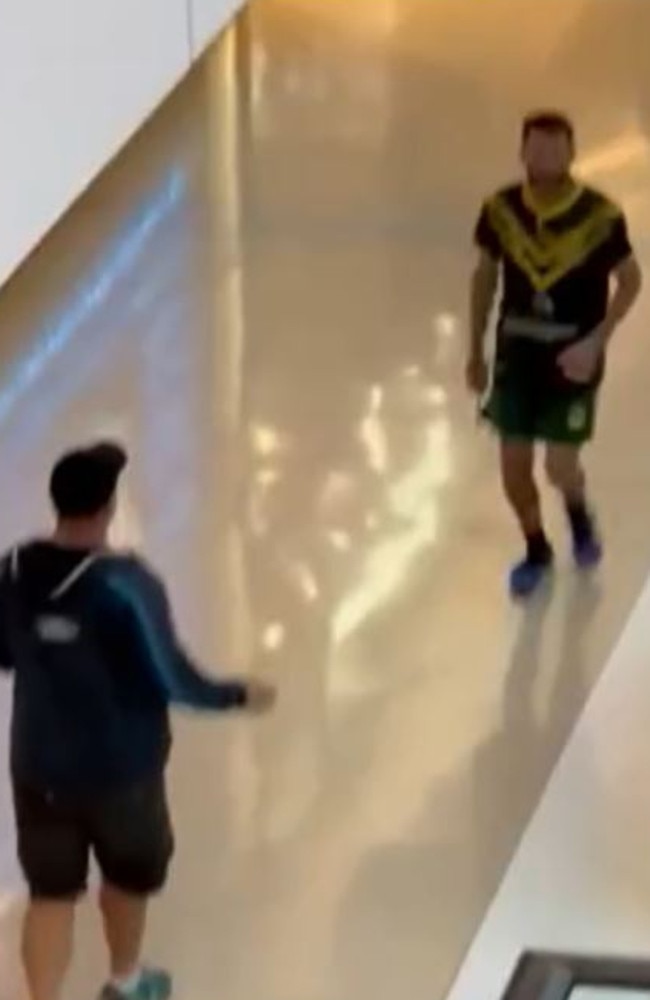 The father bravely protected his family from the suspect, seen wearing a Kangaroos jersey and armed with a large knife. Picture: 9News