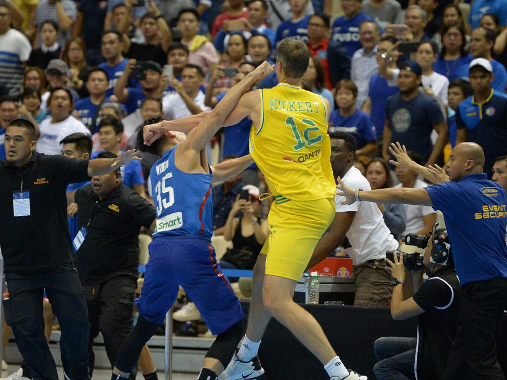 Mathew Wright (L) of the Philipines engage Daniel Kickert of Australia in a brawl during their FIBA World Cup Asian qualifier game at the Philippine arena in Bocaue town, Bulacan province, north of Manila on July 2, 2018. Australia won by default 89-53. Australia won by default 89-53. / AFP PHOTO / TED ALJIBE