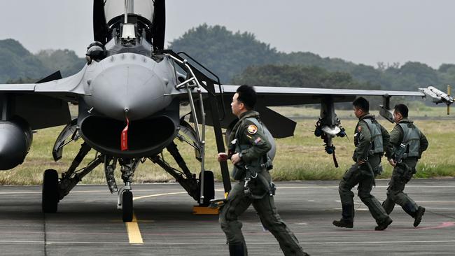 Taiwanese air force pilots run pass an armed US-made F-16V fighter at an air force base in Chiayi, southern Taiwan. Picture: AFP