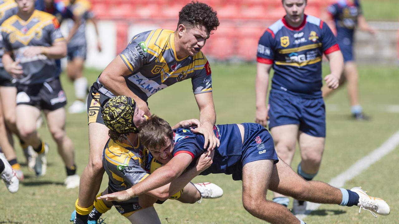 Matthew Moore for Western Clydesdales tackled by Joe Meikle (top) and James Marriott of Sunshine Coast Falcons.