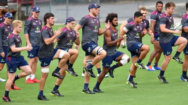 Queensland captain Liam Wright (fourth from left with mullet) leads training warm-ups at Ballymore before Saturday night’s game against the Bulls. Photo: Darren England, AAP