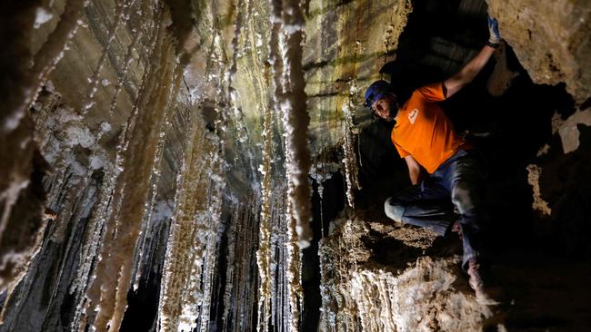 Efraim Cohen of the Israel Cave Explorers Club, and of the Malham Cave Mapping Expedition, shows journalists salt stalactites in the Malham cave inside Mount Sodom, located at the southern part of the Dead Sea in Israel on March 27, 2019. - Israeli spelunkers announced on March 27 that a salt cave near the Dead Sea was over ten kilometres long, beating Iran's N3 cave in Qeshm to make it the world's largest. The cave, named Malham, is a series of canyons running through Mount Sodom, Israel's largest mountain, and spilling out to the southwest corner of the adjacent Dead Sea. (Photo by MENAHEM KAHANA / AFP)