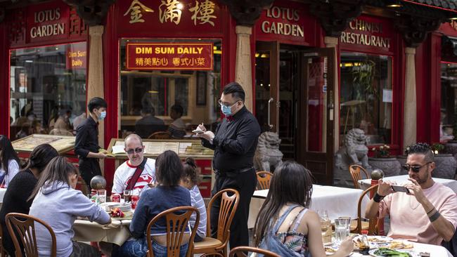 Customers dine outside in Chinatown, London, as lockdown measures are eased and people emerge from their homes – fuelling hope for an economic recovery. Picture: Getty