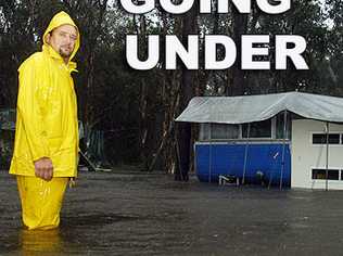 Boreen Point Caravan Park permanent resident Steve Prior watches his home going under water this afternoon. Photo: John McCutcheon.