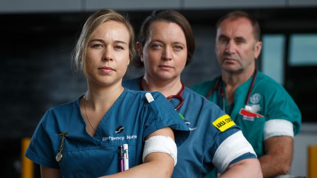 Flinders Medical Centre nurses Tegan, Megan and Bill wearing white armbands in honour of Gayle Woodford. Picture: Matt Turner.