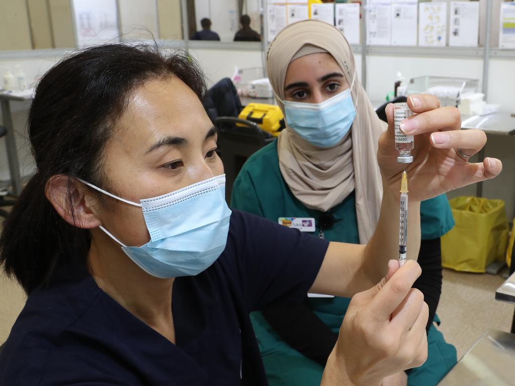 Staff prepare vaccines at the COVID-19 Vaccination Hub at the Melbourne Showgrounds. Picture: NCA NewsWire / David Crosling