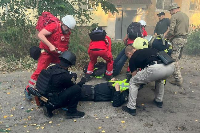 Zelensky posted photos of rescuers carrying patients down the stairs and treating two policemen