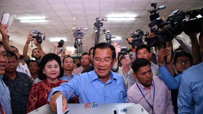 Hun Sen votes on Sunday with wife Bun Rany. Picture: AFP