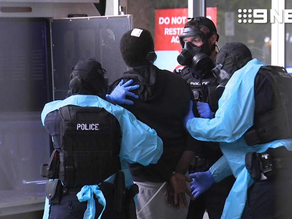SA Police wore gas masks and PPE as they arrested Mr Manjok and Mr Bol on August 4. Picture Nine News
