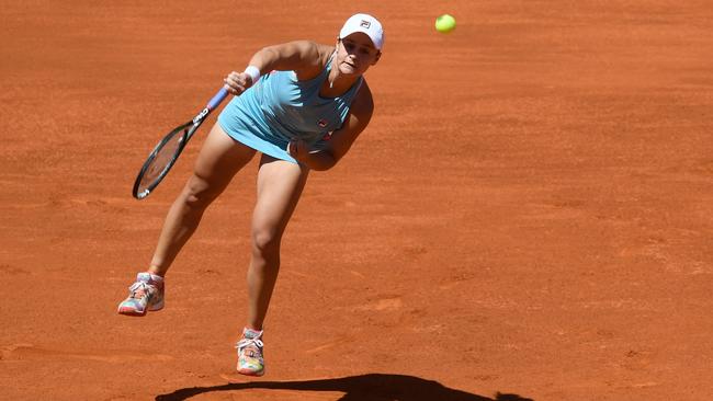 Ash Barty launches a serve on her way to a three-set win over Petra Kvitova