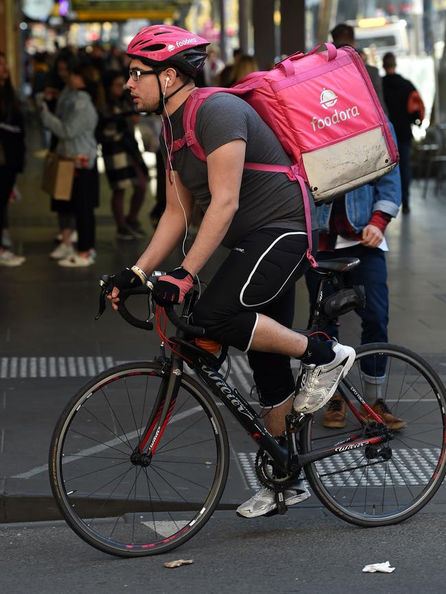 People in the city looking and listening to their phones as they make their way through the CBD Melbourne. Picture: Nicole Garmston