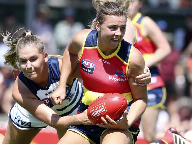 Crows Ebony Marinoff tries to handball as Cats Rebecca Webster applies a tackle. Marinoff finished Sunday’s game with an AFLW-high 33 disposals. Picture: SARAH REED