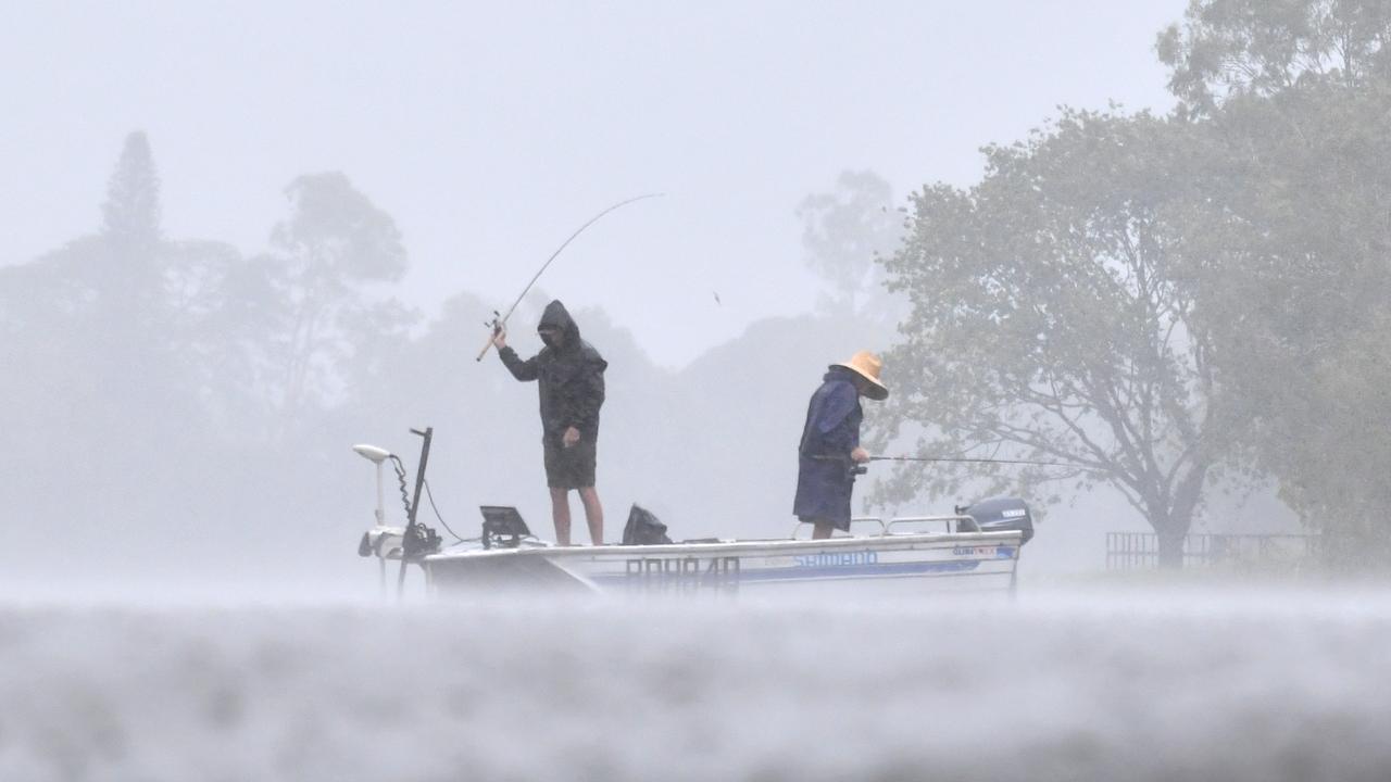 Wet weather in Townsville. Heavy rain does not stop fishing at Applins Weir. Picture: Evan Morgan