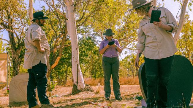 Flinders University archaeology students, Clinton Walters, Tarmia Klass and Vanessa Wakelin, in the process of recording some of the graves at Barunga cemetery. PICTURE: Dylan Benedetto