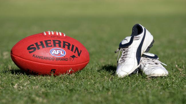 Generic AFL Sherrin football and football boots. sport /