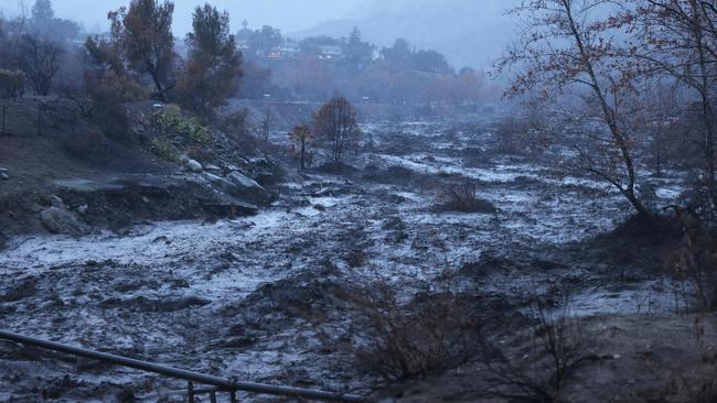 Caustic black water from the Eaton Fire rushes by in the Eaton Wash near Altadena. Picture: David Swanson / AFP