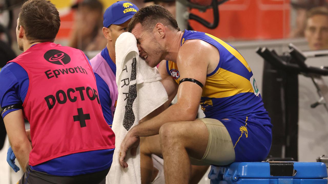 PERTH, AUSTRALIA - APRIL 03: Luke Shuey of the Eagles talks with the club physio and doctor after coming from the field during the round 3 AFL match between the West Coast Eagles and the Port Adelaide Power at Optus Stadium on April 03, 2021 in Perth, Australia. (Photo by Paul Kane/Getty Images)