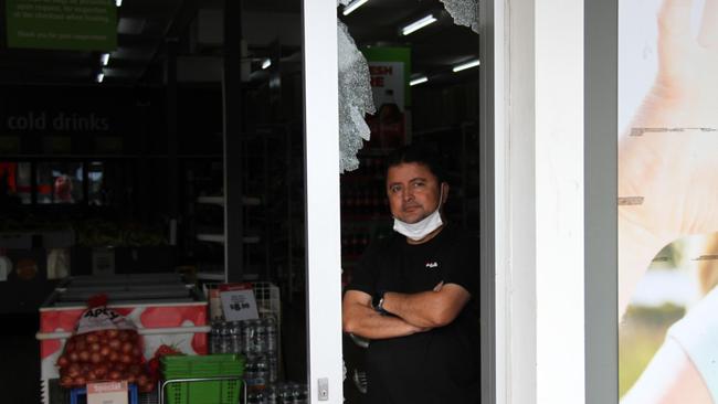 Manager Zafar Aziz shows the damage where a thief smashed into West Gladstone Foodworks just after 4am on April 11. Picture: Rodney Stevens