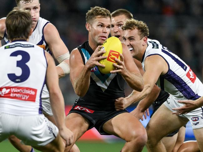 ADELAIDE, AUSTRALIA - APRIL 13:   Dan Houston of the Power  looks to handball during the round five AFL match between Port Adelaide Power and Fremantle Dockers at Adelaide Oval, on April 13, 2024, in Adelaide, Australia. (Photo by Mark Brake/Getty Images)