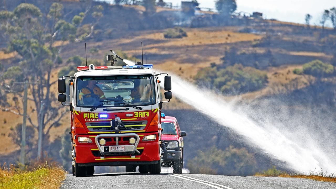 Firefighters look to contain a fire along Elderslie Road at Elderslie. Picture: ZAK SIMMONDS