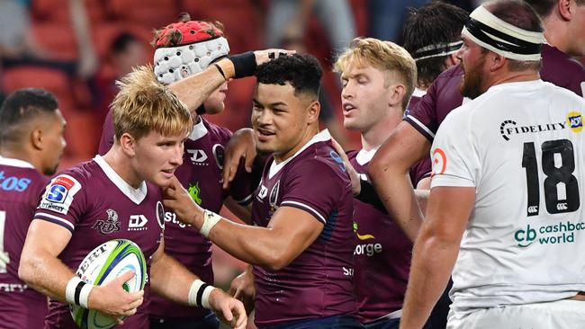 Tate McDermott (second from left) celebrates scoring a try with teammates against the Sharks last month.