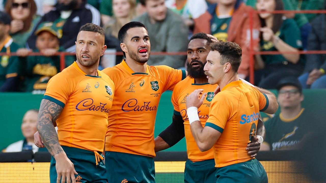 Australia's wing Marika Koroibete (2nd R) celebrates with teammates after scoring the opening try during the Rugby Championship first round match between South Africa and Australia at Loftus Versfeld stadium in Pretoria on July 8, 2023. (Photo by PHILL MAGAKOE / AFP)
