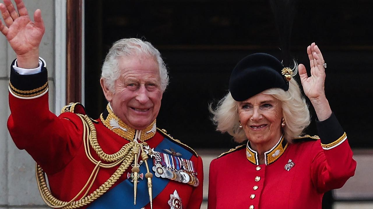 King Charles III and Britain's Queen Camilla wave from the balcony of Buckingham Palace. (Photo by Adrian DENNIS / AFP)