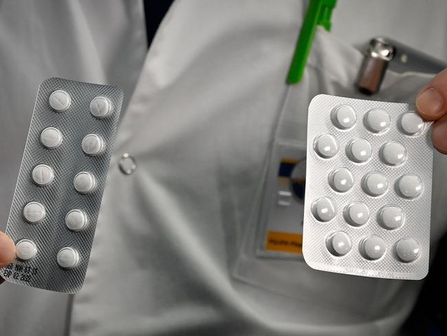 (FILES) In this file photo taken on February 26, 2020, medical staff shows o at the IHU Mediterranee Infection Institute in Marseille, packets of a Nivaquine, tablets containing chloroquine and Plaqueril, tablets containing hydroxychloroquine, drugs that has shown signs of effectiveness against coronavirus. - On March 29, 2020,a limited emergency-use authorization for two antimalarial drugs touted as game-changers by President Donald Trump has been issued by the US Food and Drug Administration to treat coronavirus patients. In a statement published Sunday, the US Department of Health and Human Services detailed recent donations of medicine to a national stockpile -- including chloroquine and hydroxychloroquine, both being investigated as potential COVID-19 treatments. (Photo by GERARD JULIEN / AFP)