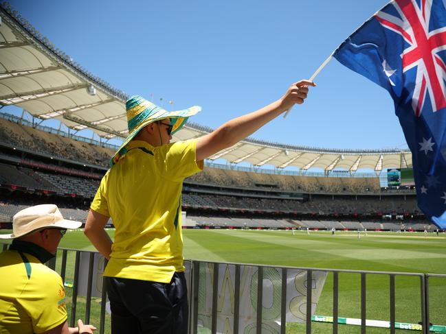 PERTH, AUSTRALIA - DECEMBER 17: Aussie Fan waves the Australian flag during day four of the Men's First Test match between Australia and Pakistan at Optus Stadium on December 17, 2023 in Perth, Australia (Photo by James Worsfold - CA/Cricket Australia via Getty Images)