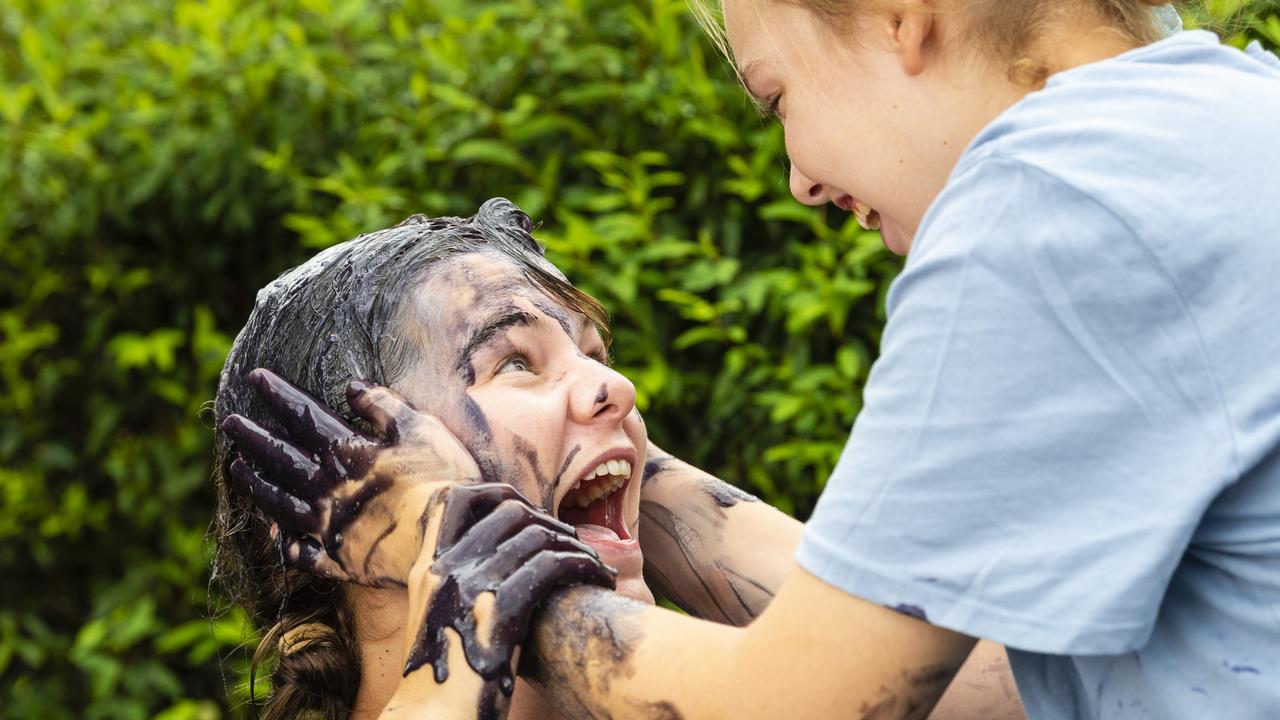 The bond of Chloe Bradford and her younger sister Bridie Bradford (right) is undeniable as she was covered in purple slime after raising money for epilepsy awareness. Monday, March 28, 2022. Picture: Kevin Farmer