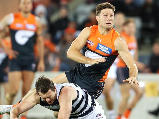 CANBERRA, AUSTRALIA - MAY 07: Toby Greene of the Giants is tackled as he kicks by Patrick Dangerfield of the Geelong Cats during the round eight AFL match between the Greater Western Sydney Giants and the Geelong Cats at Manuka Oval on May 07, 2022 in Canberra, Australia. (Photo by Mark Kolbe/Getty Images)