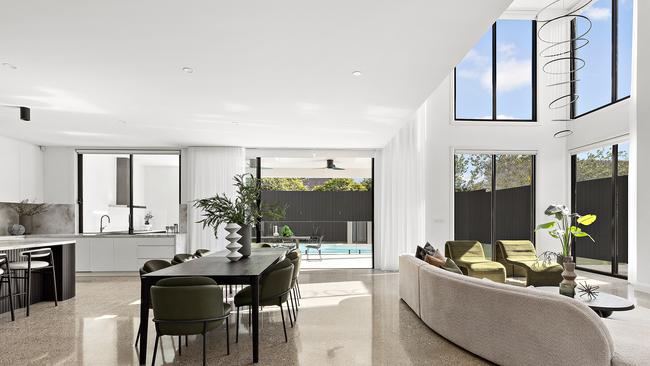 The soaring windowed walls allows natural light to flood the open-living area.