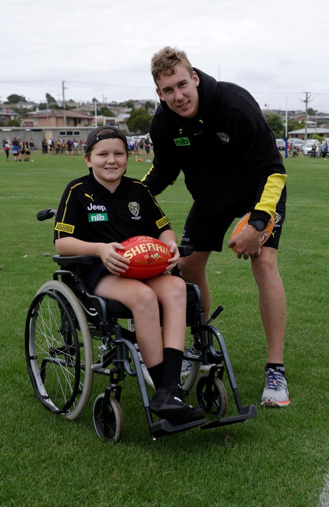 Hillcrest survivor Declean Brown and Tom Lynch of the Richmond Tigers pose for a photo during the Community Clinic at Girdlestone Park in East Devonport. Picture: Grant Viney